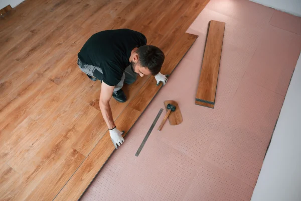 top-view-man-is-installing-new-laminated-wooden-f-2026-01-09-00-07-20-utc
